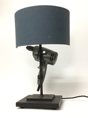 Lot 83 - An old electric drill converted to a table lamp, perfect to put on the bedside table to ensure pleasant dreams, 50cm high