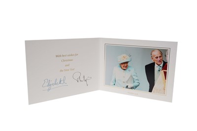 Lot 133 - H.M. Queen Elizabeth II and H.R.H. The Duke of Edinburgh 2018 signed Christmas card with twin gilt ciphers to cover, charming colour photograph of the Royal to the interior.