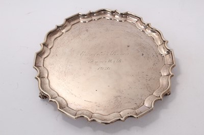 Lot 511 - Late Victorian silver salver of circular form, with pie crust border, raised on three scroll feet, with engraved presentation inscription, (London 1900), maker Wakely and Wheeler, 30ozs, 30.5cm in...