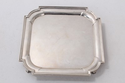 Lot 518 - Victorian silver card tray of square form, with reeded border, raised on four hoof feet, (London 1899), maker Thomas Bradbury & Sons, 8ozs, 14.5cm in diameter.