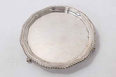 Lot 519 - Edwardian silver waiter of circular form, with gadrooned border, raised on three claw and ball feet, (London 1908), maker William Comyns & Sons Ltd, 7ozs, 15.5cm in diameter.