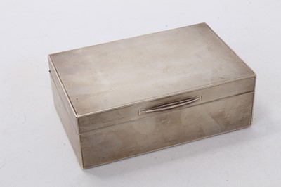 Lot 513 - George VI silver cigarette box of rectangular form with engine turned decoration, hinged lid and wood lined interior, (London 1938), 14cm in length.