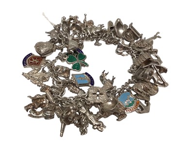 Lot 106 - Silver charm bracelet with approximately 40 charms