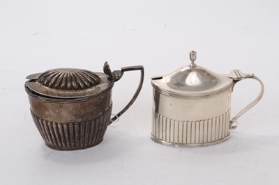 Lot 531 - Edwardian silver mustard pot of oval form with fluted decoration and reeded borders, hinged lid and blue glass liner to interior, (London 1905), maker Goldsmiths & Silversmiths Company, together wi...