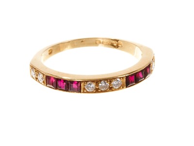 Lot 788 - Ruby and diamond eternity ring with a half hoop of calibre cut rubies and brilliant cut diamonds in 18ct yellow gold setting, ring size N.