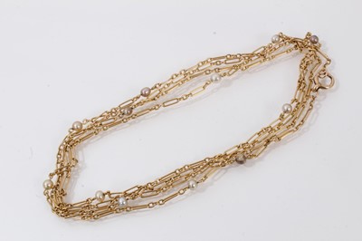 Lot 787 - Edwardian 15ct gold and pearl long chain with fetter links and 4.5-5mm pearl spacers, (pearls not tested for natural origin), length 140cm.