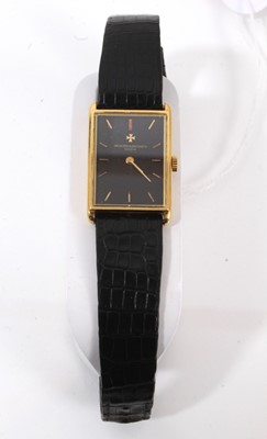 Lot 875 - Ladies Vacheron & Constantin 18ct gold wristwatch with mechanical wind movement, the rectangular black dial with gold baton hour markers in an 18ct gold tank shape case on leather strap, case 28 x...