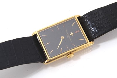 Lot 875 - Ladies Vacheron & Constantin 18ct gold wristwatch with mechanical wind movement, the rectangular black dial with gold baton hour markers in an 18ct gold tank shape case on leather strap, case 28 x...
