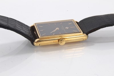 Lot 875 - Ladies Vacheron & Constantin 18ct gold wristwatch with mechanical wind movement, the rectangular black dial with gold baton hour markers in an 18ct gold tank shape case on leather strap, case 28 x...