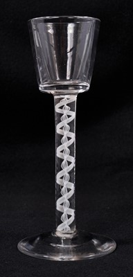 Lot 312 - A Georgian wine or cordial glass, c. 1760, the bucket bowl over an opaque twist stem consisting of a 12-ply spiral band outside an 8-ply corkscrew, conical foot, 16.5cm high