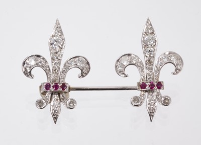 Lot 849 - Good quality diamond and ruby jabot pin brooch with a double fleur-de-lis, set with brilliant cut diamonds and rubies, in white gold setting, estimated total diamond weight approximately 2.2cts. In...