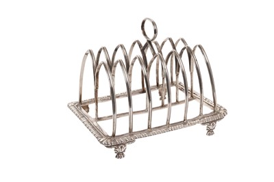 Lot 550 - Large George III, six division toast rack of rectangular form, with Gothic arch frame and gadrooned base, on on four paw feet (London 1814) maker's mark rubbed. All at approximately 10ozs. 15.5cm a...