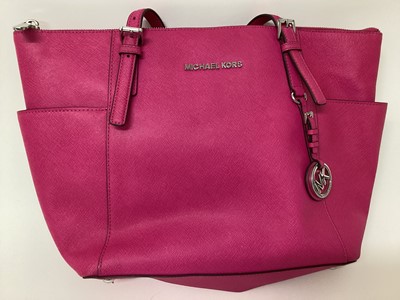 Lot 2079 - Michael Kors Tote bag in Cerise with a gold Michael Kors purse. With large dust bag.