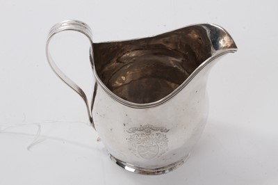 Lot 552 - George III silver helmet cream jug, with engraved armorial, reeded border and handle