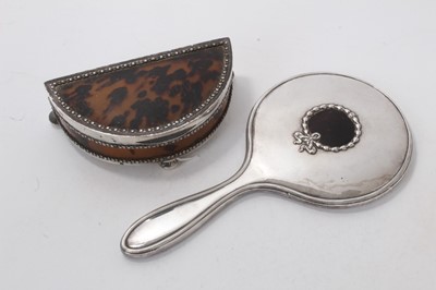 Lot 558 - George V silver mounted tortoiseshell dressing table box of half moon form, with hinged cover, on three bun feet (London 1913) Charles Boyton & Son Ltd, together with a silver and tortoiseshell mou...