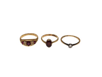 Lot 4 - 18ct gold diamond single stone ring, 18ct gold garnet single stone ring and 18ct gold ruby and diamond ring (3)