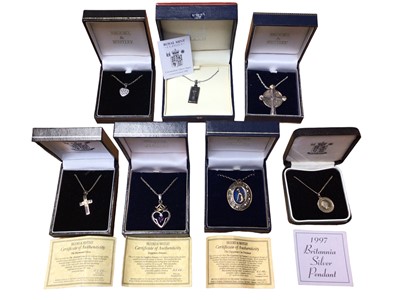 Lot 16 - Royal Mint silver ingot pendant, silver Egyptian cat pendant, 1997 Britannia Silver coin pendant, two silver cross pendants and two gem set heart pendants, all on silver chains and boxed (7)