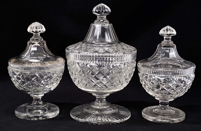 Lot 343 - A garniture of three 19th century cut glass sweetmeat urns and covers, 19cm to 23cm high