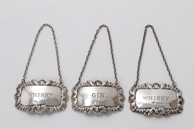 Lot 539 - Three contemporary silver decanter labels.