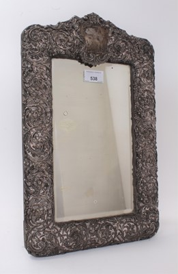 Lot 538 - Edwardian silver mounted easel dressing table mirror with pierced and embossed floral decoration, (Birmingham 1902). 42cm x 27cm.