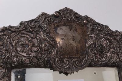 Lot 538 - Edwardian silver mounted easel dressing table mirror with pierced and embossed floral decoration, (Birmingham 1902). 42cm x 27cm.