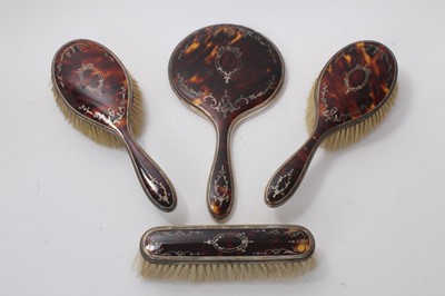 Lot 609 - George V silver and tortoiseshell piquet work four piece brush and mirror set, (Birmingham 1923), maker Adie Brothers (4)