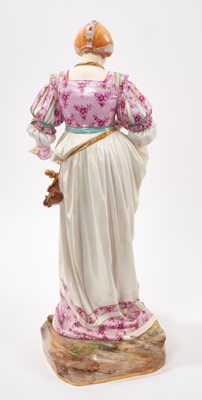 Lot 348 - Large Meissen figure of a lady and her cat, the lady modelled in Renaissance costume on naturalistic plinth base, blue crossed swords, pressnumber 63, 41cm high