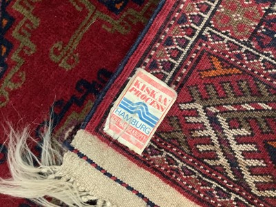 Lot 1716 - Tekke style rug, with repeat quartered medallions on claret ground and in multiple geometric borders, 186 x 116cm