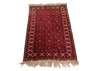 Lot 1719 - Belouch rug, having three rows of seven medallions on claret ground, in multiple geometric borders, 185 x 126cm