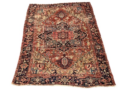 Lot 1722 - Large Heriz rug, with typical angular vibe ornament on brick red ground, in conforming borders, 320 x 245cm