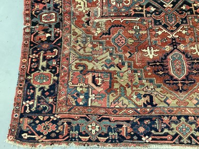 Lot 1722 - Large Heriz rug, with typical angular vibe ornament on brick red ground, in conforming borders, 320 x 245cm