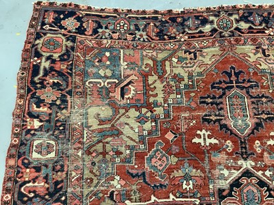 Lot 1722 - Large Heriz rug, with typical angular vibe ornament on brick red ground, in conforming borders, 320 x 245cm