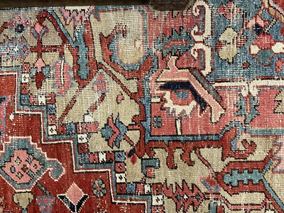 Lot 1722 - Large Heriz rug, with typical angular vibe ornament on brick red ground, in conforming borders, 320 x 245cm