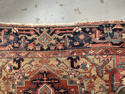 Lot 1722 - Large Heriz rug, with typical angular vibe ornament on brick red ground, in conforming borders, 320 x 245cm