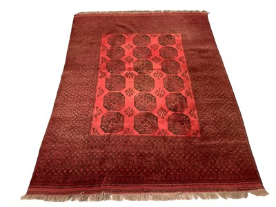 Lot 1726 - Large belouch rug, with three rows of quartered medallions on claret ground, in multiple borders, 260cm wide