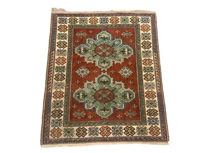 Lot 1727 - Small Kazak rug, with two cruciform medallions on umber ground in geometric borders, 180 x 150cm