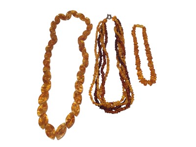Lot 237 - Amber bead torsade necklace with silver clasp, 48.5cm long and two other reconstituted amber bead necklaces (3)