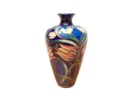 Lot 1194 - Moorcroft pottery vase with floral decoration on two tone blue ground, dated 2004, 16cm high