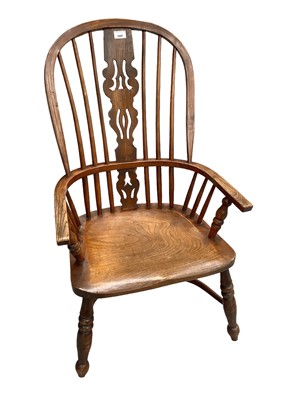 Lot 1697 - Antique elm Windsor elbow chair of typical form, on turned supports