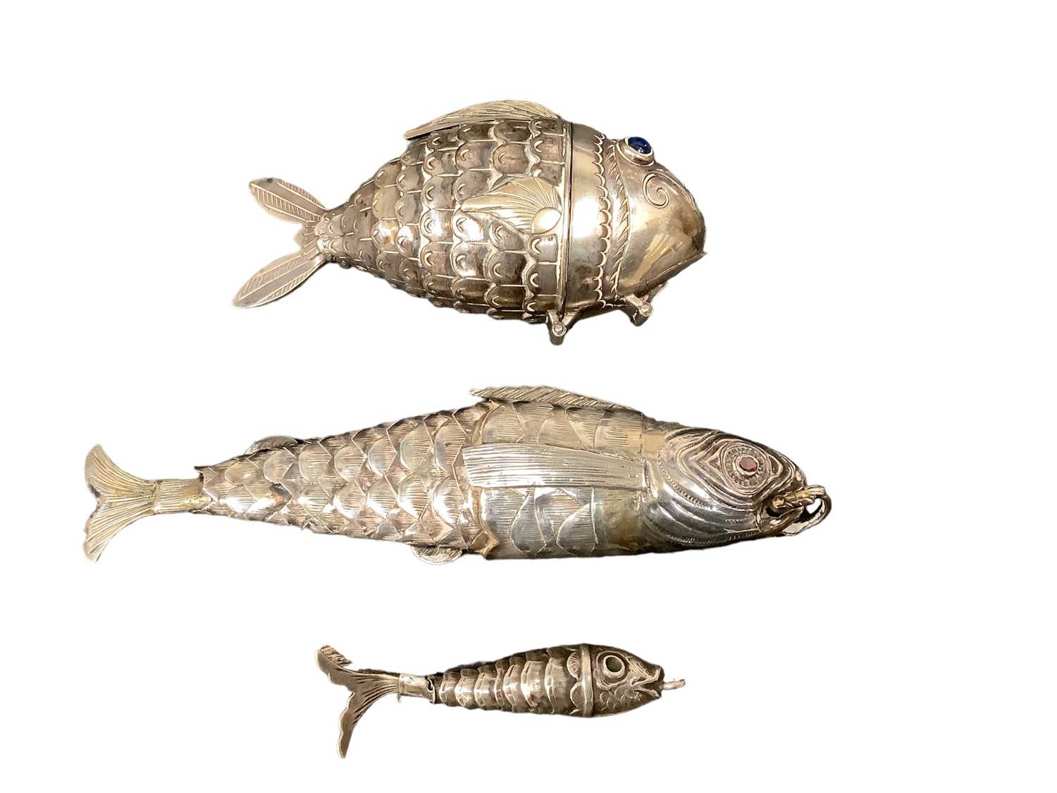 Lot 2443 - Three antique white metal articulated fish,