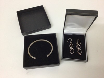 Lot 109 - Contemporary silver bangle of plain form, together with a pair of modern silver earrings