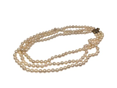 Lot 141 - Cultured pearl necklace with a triple strand of 6-6.5mm cultured pearls on a 14ct gold and diamond clasp