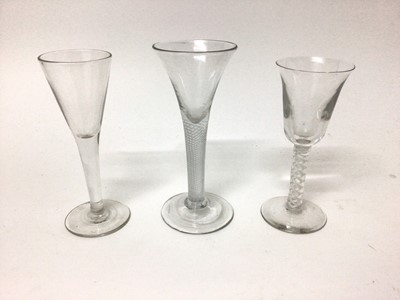 Lot 27 - A Georgian multi-spiral air twist stem wine glass, together with a plain stem wine glass and a Continental opaque twist stem wine glass (3)