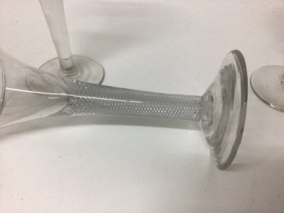 Lot 27 - A Georgian multi-spiral air twist stem wine glass, together with a plain stem wine glass and a Continental opaque twist stem wine glass (3)