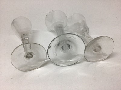 Lot 27 - A Georgian multi-spiral air twist stem wine glass, together with a plain stem wine glass and a Continental opaque twist stem wine glass (3)