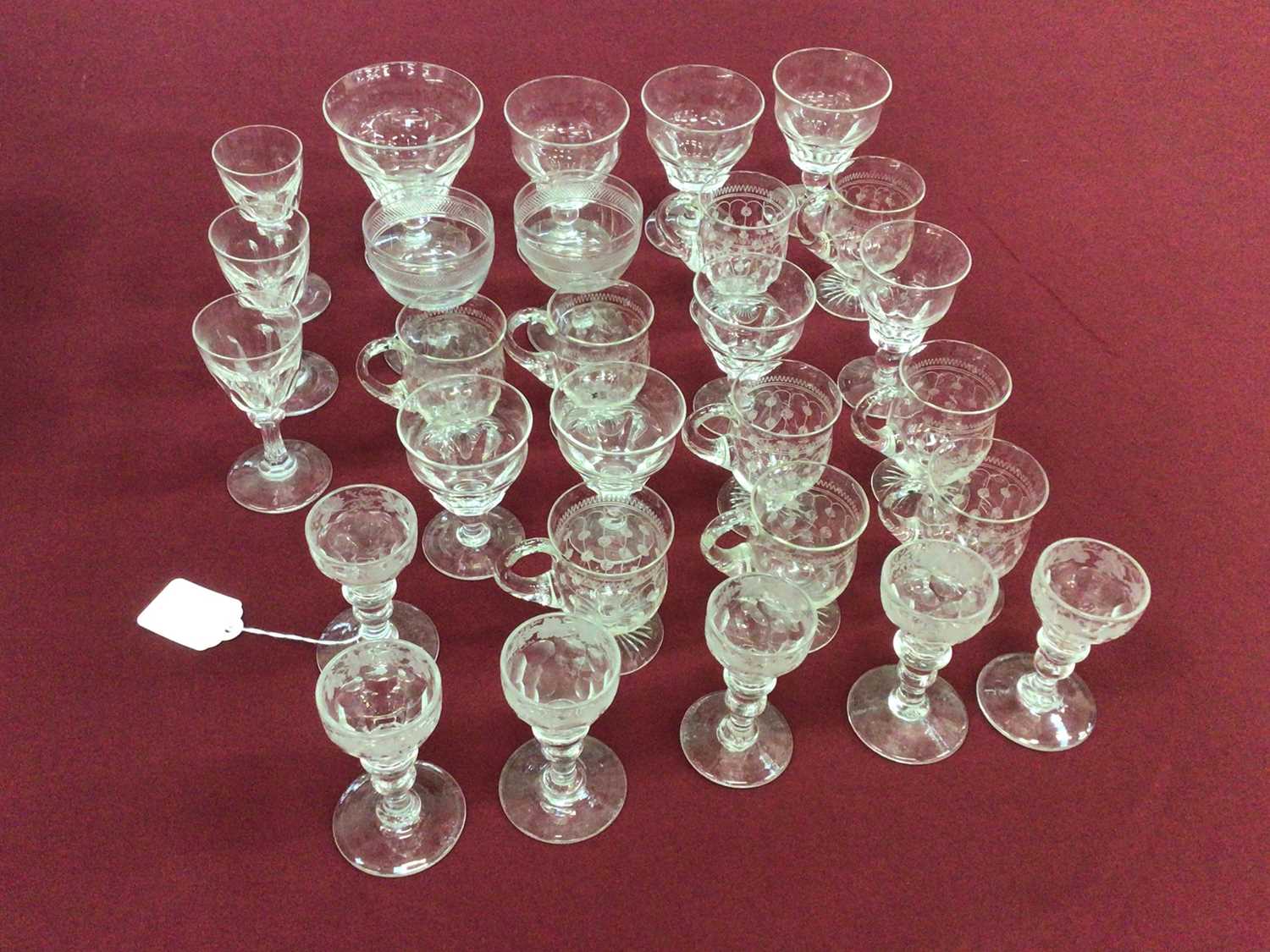 Lot 40 - A group of Victorian and later glassware, including a set of nine Edwardian etched custard cups, a set of six Victorian vine-etched sherry glasses, a pair of engraved coupes, a group of eight Stuar...