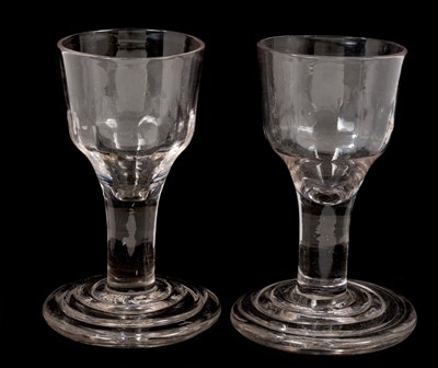 Lot 41 - A pair of Georgian firing glasses, with moulded ogee bowls, plain stems and stepped bases