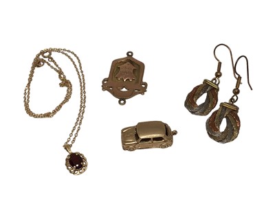 Lot 46 - 9ct gold fob, 9ct gold Mini car charm, 9ct gold garnet pendant on 9ct gold chain and pair of three colour metal earrings