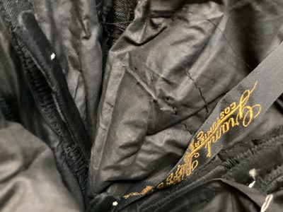 Lot 2104 - Edwardian evening dress in black satin with beaded net overlay, high waist and asymmetric draping and fringing.