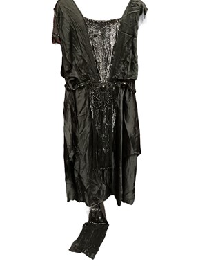 Lot 2105 - 1920s/30s black silk evening dress with draped beading, long beaded fringing, sequin panels and train .